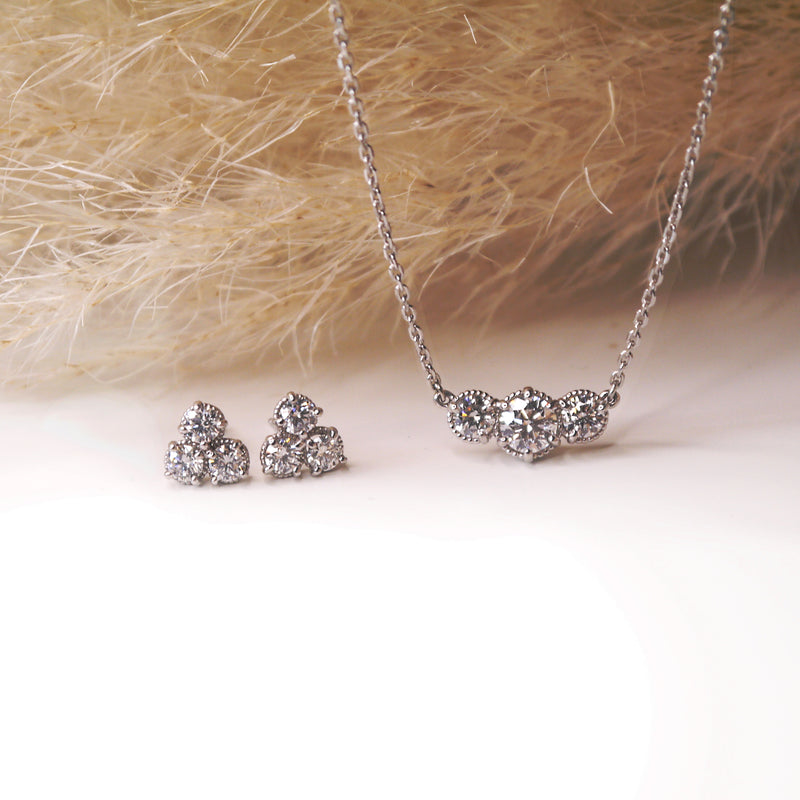 Marigold three stone diamond necklace shown with diamond studs.  daily wear for boho minded ladies