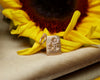 Sunflower charm on a yellow sunflower with a beige background