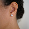 Marigold 14kt white gold diamond stud earrings three beaded pods on the model's ear Ellie Lee Fine Jewelry